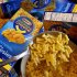 FILE - This Feb. 9, 2011, file photo, shows Kraft Macaroni & Cheese in Chandler, Ariz. When Kraft revealed that it planned to name its new global snack business “Mondelez,” it caused a minor stir. Kraft was careful to explain that the made-up word is an amalgamation of the Latin word for “world” and “a fanciful expression” of the word “delicious.” The linguistic concoction was the result of a four-month long process that reflects the extensive consumer research and vetting names are subject to in the corporate world. It also brings to light the powerful role language can play in shaping appetites and even dictating a brand’s fate. The right name might even persuade consumers to detect phantom homespun qualities in packaged snacks that rolled off a factory conveyor belt.   (AP Photo/Matt York, File)