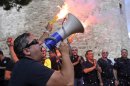 Coast guards hold flares and shout slogans in front of White Tower, city's landmark, during a protest in the northern Greek port city of Thessaloniki, Saturday, Sept. 8, 2012. Greece, in the grip of a severe recession for the fifth straight year, is still struggling to avoid bankruptcy by imposing harsh austerity measures, including wage and pension cuts. Unemployment has soared to nearly a quarter of the workforce. (AP Photo/Giorgos Nissiotis)