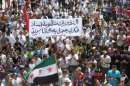 An image released by the Syrian opposition's Shaam News Network, shows an anti-regime demonstration in the town of Dael