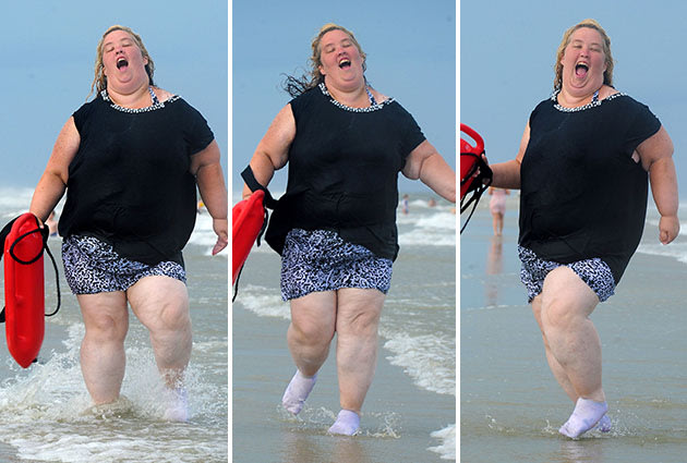 Mama June Shannon runs on the beach with a lifeguard buoy in Tybee, GA. "Honey Boo Boo" and family hit up the Tybee Island Beach in Georgia for a mini vacation. June wore sock on the beach due to her mangled foot from a fork lift accident. They call it the fork lift foot and thats why June is wearing her socks on the beach.