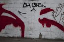A graffiti depicts an image of the eyes of Venezuela's President Hugo Chavez in Caracas, Venezuela, Tuesday, Dec. 18, 2012. Chavez is recovering in Cuba from a surgery, his fourth operation related to his pelvic cancer since June 2011. (AP Photo/Ariana Cubillos)