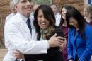 Patient Nina Pham is hugged by Dr. Anthony Fauci, director of the National Institute of Allergy and Infectious Diseases outside of National Institutes of Health in Bethesda, Md., Friday, Oct. 24, 2014. Pham, the first nurse diagnosed with Ebola after treating an infected man at a Dallas hospital is free of the virus. The 26-year-old Pham arrived last week at the NIH Clinical Center. She had been flown there from Texas Health Presbyterian Hospital Dallas. (AP Photo/Pablo Martinez Monsivais)