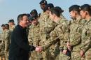 Britain's Prime Minister David Cameron (L) talks to British soldiers during a visit at Camp Bastion, outside Lashkar Gah, the provincial capital of Helmand province in southern Afghanistan on December 16, 2013