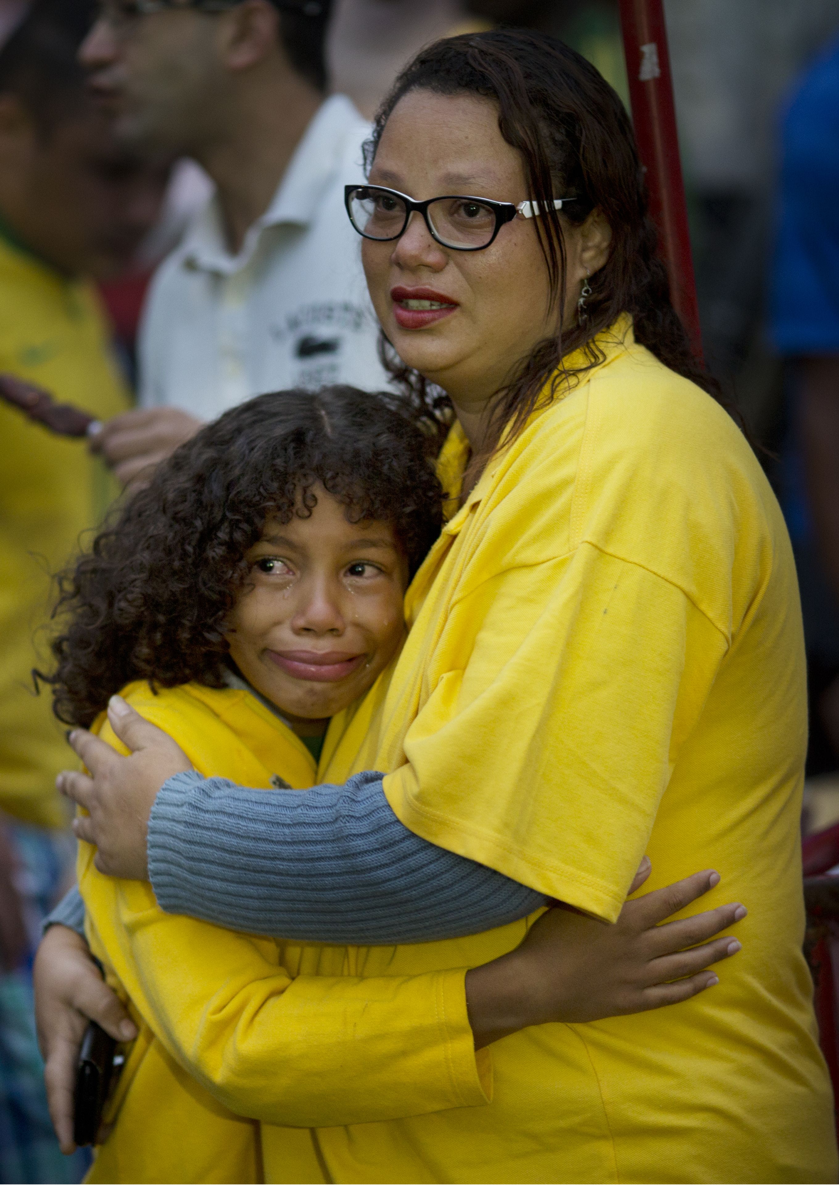 Brazil fans embrace as they watch their team lose to Germany. (AP)