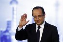 France's President Hollande waves as he delivers a speech during a meeting at the French consul general's residence in Shanghai