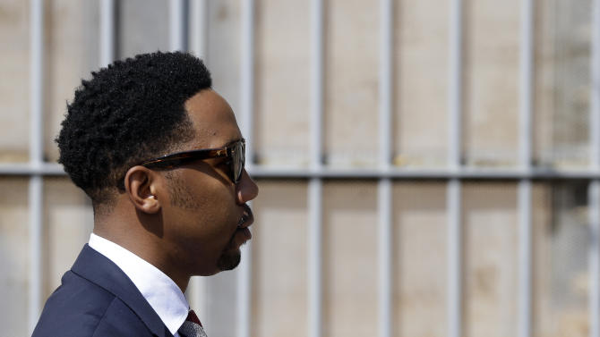 Grandson of former South African president Nelson Mandela, Ndaba Mandela walks out of the magistrates court where his brother Mbuso Mandela is scheduled to appear accused of raping a 15-year-old girl, in Johannesburg, South Africa, Friday, Aug. 21, 2015.  The grandson of Nelson Mandela, Mbuso Mandela appeared in court accused of raping a 15-year-old girl, where a judge will decide whether he will be granted bail.  (AP Photo/Themba Hadebe)