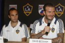 Galaxy's Beckham answers media queries while Donovan watches during a news conference in Manila