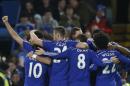 Chelsea's Diego Costa, left, is mobbed by his teammates after scoring his sides second goal during their English Premier League soccer match between Chelsea and Hull City at Stamford Bridge stadium in London, Saturday, Dec 13, 2014. (AP Photo/Alastair Grant)