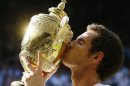 Andy Murray of Britain poses with the trophy after defeating Novak Djokovic of Serbia during the Men's singles final match at the All England Lawn Tennis Championships in Wimbledon, London, Sunday, July 7, 2013. (AP Photo/Kirsty Wigglesworth)