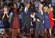 President Barack Obama , joined by his wife Michelle, Vice President Joe Biden and his spouse Jill acknowledge applause after Obama delivered his victory speech to supporters gathered in Chicago early Wednesday Nov. 7 2012. (AP Photo/Jerome Delay)