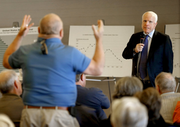 U.S. Sen. John McCain, R-Ariz., listens to a question during a town hall, Tuesday, Feb. 19, 2013, in Sun Lakes, Ariz. McCain defended his proposed immigration overhaul to an angry crowd in suburban Arizona in the latest sign that this border state will play a prominent role in the national immigration reform debate. (AP Photo/Matt York)