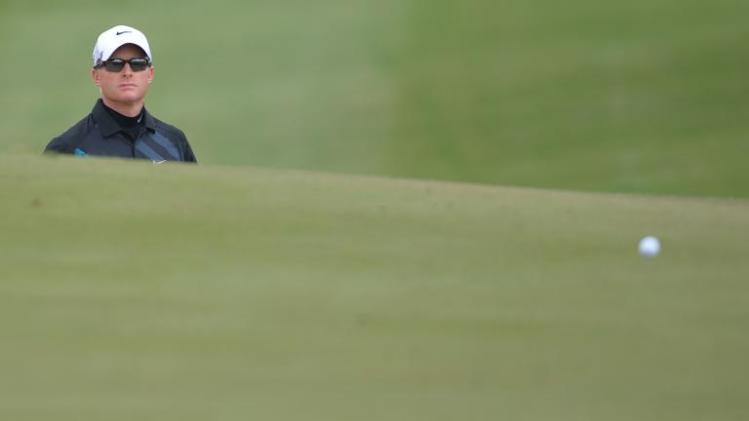 Simon Dyson of England watches the ball after a bunker shot at the first hole, during the second round of the BMW Shanghai Masters tournament, at the Lake Malaren Golf Club in Shanghai, on October 25, 2013