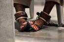 A Guantanamo detainee's feet are shackled to the floor as he attends a "Life Skills" class at Guantanamo Bay U.S. Naval Base