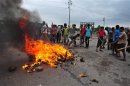 Activists of Hefajat-e Islam set fire to tyres and pieces of wood as they block a street during a clash with the police in Narayanganj