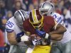 Washington Redskins running back Alfred Morris is tackled by Dallas Cowboys nose tackle Sean Lissemore (95) and defensive end Jason Hatcher (97) during the first half of an NFL football game Sunday, Dec. 30, 2012, in Landover, Md. (AP Photo/Alex Brandon)