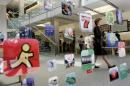 Woman walks past icons for Apple Apps at San Francisco retail store