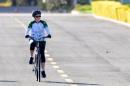 Suspended Brazilian President Dilma Rousseff rides her bicycle in the area of the Alvorada Palace in Brasilia on August 28, 2016