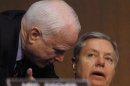 Senators McCain and Graham confer at the Senate Armed Services Committee in Washington