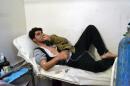 A young man breathes with an oxygen mask on March 17, 2015 at a clinic in the village of Sarmin, southeast of Idlib following reports of an alleged regime gas attack in the area