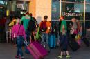 Tourists leave Tunisia at the Enfidha International airport after a shooting in the resort town of Sousse, a popular tourist destination 140 kilometres south of the Tunisian capital, on June 27, 2015