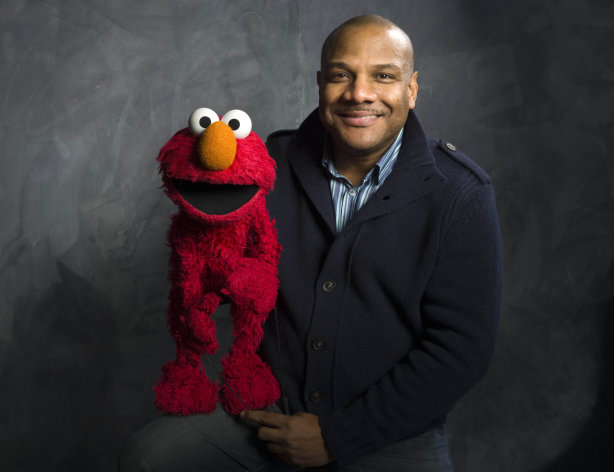 FILE - In this Jan. 24, 2011 file photo, Elmo puppeteer Kevin Clash poses with the "Sesame Street" muppet in the Fender Music Lodge during the 2011 Sundance Film Festival in Park City, Utah. Sesame Workshop says Elmo puppeteer Kevin Clash has resigned from "Sesame Street" in the wake of allegations that he had sex with an under-aged youth. Last week a man accused Clash of having sex with him when he was a teenage boy, a charge Clash denied. A day later, the man recanted his charge. A lawsuit by a second accuser was filed Tuesday, Nov. 20, according to attorney Cecil Singleton. (AP Photo/Victoria Will, File)