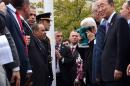 Palestinian president Mahmud Abbas kisses the Palestinian flag as Secretary General Ban Ki-moon looks during the flag raising ceremony on September 30, 2015 at the UN in New York