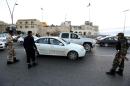 Libyan security force members man a checkpoint on February 3, 2013, in Tripoli