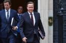 British Prime Minister David Cameron (C) exits 10 Downing Street in central London on September 7, 2015