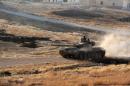 Opposition fighters drive a tank in the Al-Huweiz area on the southern outskirts of Aleppo as they battle to break the government seige on the northen Syrian city on August 2, 2016