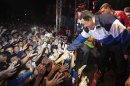 Venezuela's President and presidential candidate Hugo Chavez shakes hands with supporters in Caracas