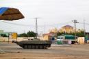 A Sudanese tank is stationed near a security facility in the city of Nyala, Darfur region, on July 4, 2013
