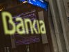 The Stock Exchange main display is reflected on a Bankia sign in Madrid, Monday, May 28, 2012.  Shares in Spanish bank Bankia, one of the banks hardest hit by Spain's real estate collapse over the past four years, fell 28 per cent on opening in Madrid on Monday, the bank's first day back on the stock exchange following its announcement Friday that it would need Euro 19 billion ($23.8 billion) bailout to bolster its defenses.(AP Photo/Daniel Ochoa de Olza)