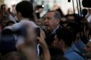 Turkish President Erdogan speaks to the crowd following a funeral service for victims of the thwarted coup in Istanbul