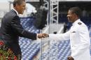 FILE - In this May 22, 2009 file photo, President Barack Obama fist bumps Chauncy Lorrell Gray, from Chicago, as he approaches the stage to receive his diploma at the United States Naval Academy graduation ceremony in Annapolis, Md. The familiar knocking of knuckles spreads only one-twentieth the amount of bacteria that a handshake does, researchers report. That's better than a high-five, which still passes along less than half the amount as a handshake. (AP Photo/Charles Dharapak, File)