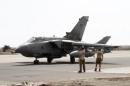 Servicemen stand near a British Tornado jet preparing to takeoff at the RAF Akrotiri in Cyprus