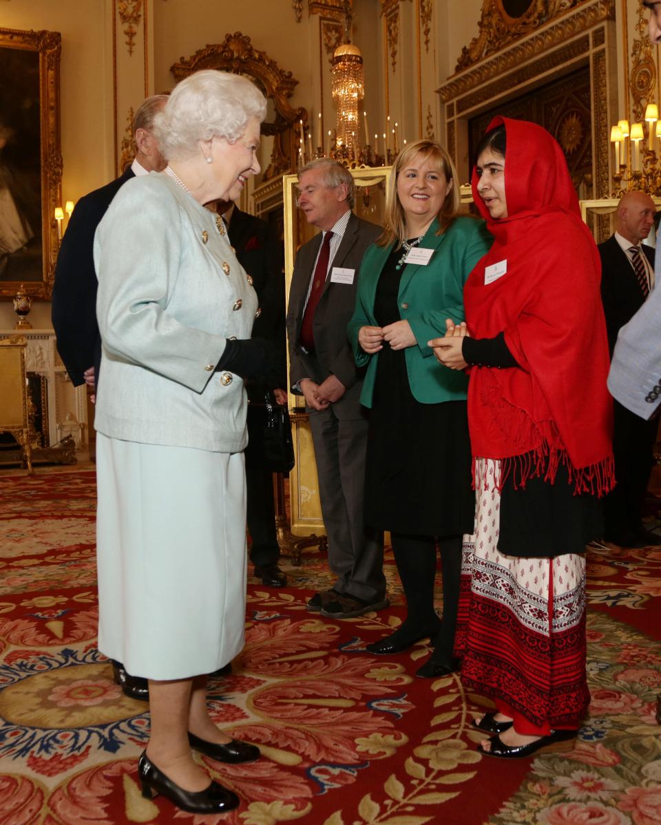 Britain's Queen Elizabeth II meets Malala Yousafzai during a reception for youth, education and the Commonwealth at Buckingham Palace, London, Friday Oct. 18, 2013. The Pakistani teenager, an advocate for education for girls, survived a Taliban assassination attempt last year on her way home from school. (AP Photo/Yui Mok, Pool)