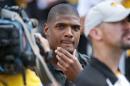 Former Missouri player Michael Sam watches pregame festivities before the start of the South Dakota State-Missouri NCAA college football game Saturday, Aug. 30, 2014, in Columbia, Mo. Sam, the first openly gay player drafted by an NFL team, was released by St. Louis Rams Saturday. (AP Photo/L.G. Patterson)