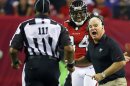 Atlanta Falcons head coach Mike Smith, right, argues for a pass interference call on a play involving wide receiver Roddy White, center, with an official during the second half of their NFL football game against the Denver Broncos, Monday, Sept. 17, 2012, in Atlanta. The Falcons won 27-21. (AP Photo/Atlanta Journal-Constitution, Curtis Compton) MARIETTA DAILY OUT; GWINNETT DAILY POST OUT; LOCAL TV OUT; WXIA-TV OUT; WGCL-TV OUT