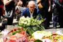 Australian Prime Minister Malcolm Turnbull lays a floral tribute in central Melbourne, Australia, to the victims killed and injured when a man drove into pedestrians on Friday