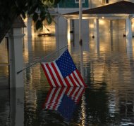 A submerged American flag shows the devastation of a flood in downtown Cedar Rapids, Iowa, June 13, 2008.