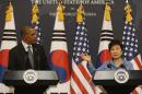 Obama listens to Park at a news conference in Seoul