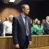 Olympian Oscar Pistorius stands following his bail hearing in Pretoria, South Africa, Tuesday, Feb. 19, 2013. Pistorius fired into the door of a small bathroom where his girlfriend was cowering after a shouting match on Valentine's Day, hitting her three times, a South African prosecutor said Tuesday as he charged the sports icon with premeditated murder. The magistrate ruled that Pistorius faces the harshest bail requirements available in South African law. He did not elaborate before a break was called in the session. (AP Photo)