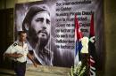 A police officer passes by a large portrait of late Cuban revolutionary leader Fidel Castro at the City Hall of the Guanabacoa municipality in Havana, on November 28, 2016