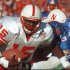 FILE - In this Nov. 11, 1995, file photo, Nebraska quarterback Tommie Frazier (15) runs to inside the one-yard line as Kansas defensive tackle Dewey Houston (83) tries to stop his progress during the first quarter of an NCAA college football game in Lawrence, Kan. Frazier was selected to the College Football Hall of Fame on Tuesday, May 7, 2013.  (AP Photo/Cliff Schiappa, File)