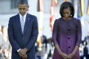 President Barack Obama and first lady Michelle Obama, joined by members of the White House staff pause during a moment of silence to mark the 11th anniversary of the Sept, 11th, Tuesday, Sept. 11, 2012, on the South Lawn of the White House in Washington. (AP Photo/Carolyn Kaster)
