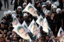 Demonstrators hold flags with pictures of imprisoned Kurdish rebel leader Abdullah Ocalan, during a protest against latest security operations in Diyarbakir, Turkey