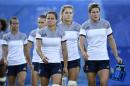 France's Camille Grassineau (front L), Marjorie Mayans (C) and Caroline Ladagnous walk on the field during the women's rugby sevens event on August 6, 2016