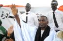 Mauritania opposition politician, presidential candidate, and anti-slavery activist Biram Dah Abeid waves at supporters as he takes part in a campaign rally, in Nouackchott, on June 19, 2014