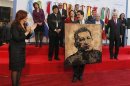 Argentina's President Fernandez applauds after giving Venezuela's Foreign Minister Maduro a portrait of President Chavez painted by Argentine artist Filippo as a souvenir during the annual summit of the Mercosur trade bloc in Mendoza