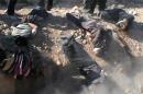 Picture released by al-Nusra Front's media arm allegedly shows bodies lying on the ground after men were executed by members of the Jihadist group in the eastern Ghouta suburb of Damascus, on November 26, 2013